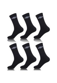 Chaussettes en coton noires, six paires, longueur mi-mollet, avec des accents de logo blancs sur les poignets, texture lisse, design simple et sans motifs visibles.