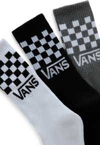 Tre par strumpor; svarta, vita och grå. Var och en har ett rutmönster och 'VANS'-logotypen i fet stil. Ribbad struktur upptill.