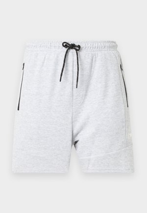 Pantalones cortos de sudadera grises hechos de una tela suave, con una cintura elástica y cordón, bolsillos laterales con cierre y un acento de logo minimalista.