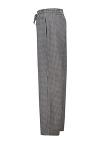 Black and white checked pants with an elastic waist and drawstring, featuring a loose fit and smooth fabric texture.