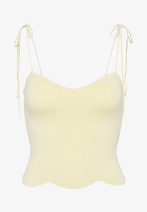 Top corto in maglia a coste color crema con spalline regolabili da legare e orlo smerlato.