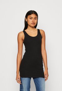 Camiseta sin mangas de algodón negro con escote redondeado y corte ajustado. Presenta tirantes anchos y un dobladillo recto. Sin patrones ni adornos.