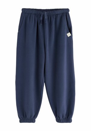 Pantaloni della tuta blu navy con vita e polsini elasticizzati, tasche laterali, coulisse e una piccola etichetta bianca con un'icona arcobaleno sulla tasca destra.