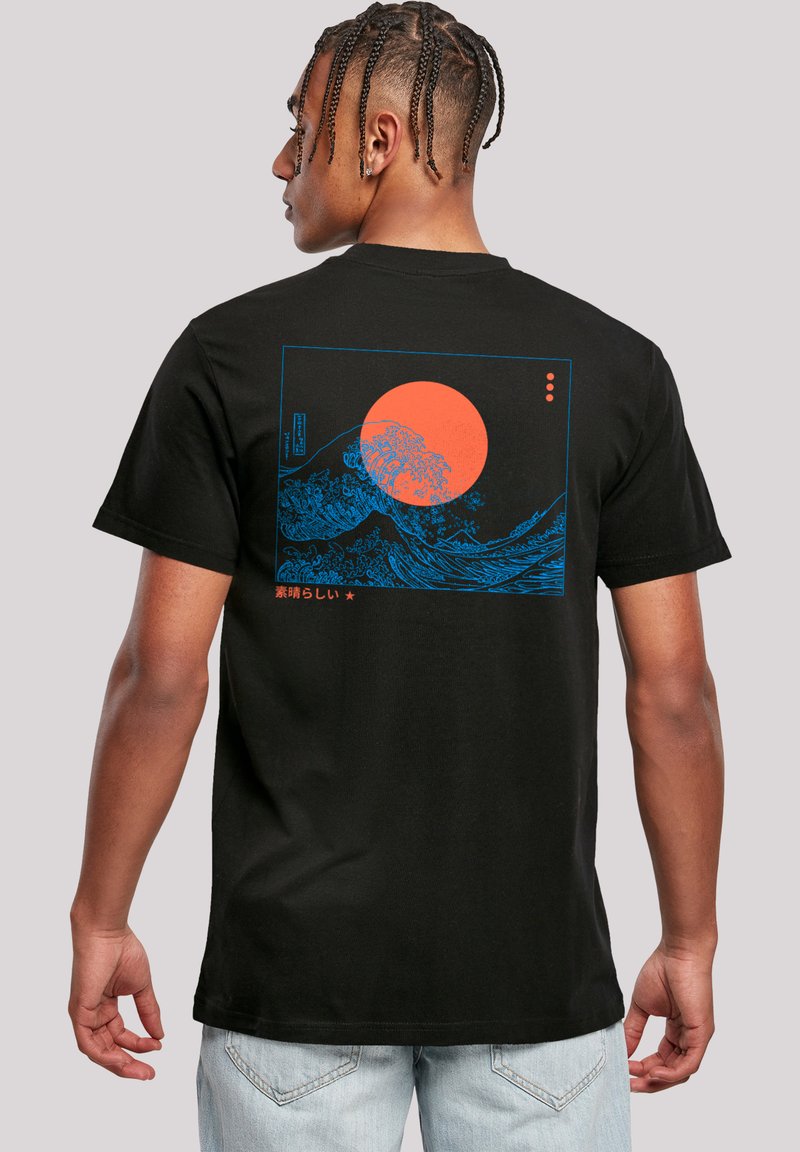Black cotton t-shirt featuring a blue graphic design of waves and a bright orange sun on the back, with Japanese text below the illustration.