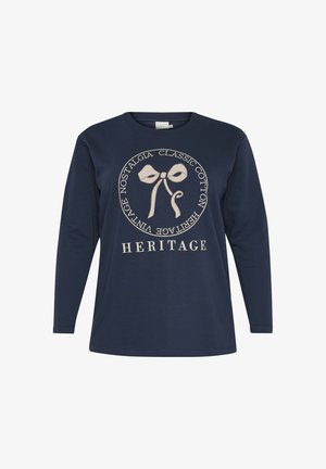 Tumesinise pika varrukaga T-särk pehmest puuvillast, millel on kreemivärvi lipsugraafika ja ümmargune tekstidisain, mille all on tekst "PÄRAND".