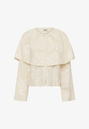 Cremefarbene Langarmbluse mit bestickten Blumenmustern und einem geschichteten, capeartigen Kragen, der vorne mit Knöpfen geschlossen wird.