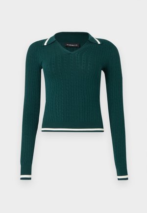 Tumedrohelise soonikkoelusega pika varrukaga kampsun V-kaeluse, polosärgikaeluse ja valgete triipudega kaelusel, mansettidel ja äärel.