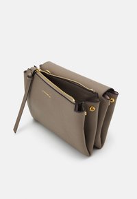 Gray leather bag with gold zipper and hardware, dual compartments with a textured finish, featuring a side strap for carrying.