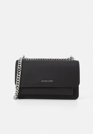 Sac à épaule Michael Kors en cuir noir texturé avec bandoulière chaîne argentée et fermeture à rabat, présenté sur fond blanc.