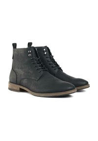 Black vegan leather ankle boots with a smooth texture, lace-up front, silver eyelets, and a brown rubber sole.