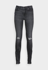 Jeans skinny de mezclilla oscura con roturas desgastadas en las rodillas, diseño de cinco bolsillos y detalles de cremallera en los puños. Textura suave y silueta ajustada.