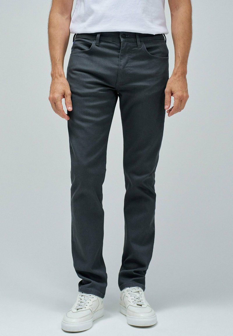 Sive jeans iz bombažne mešanice slim fit kroja, s petimi žepi in kontrastnim šivanjem, obuti z belimi supergami.