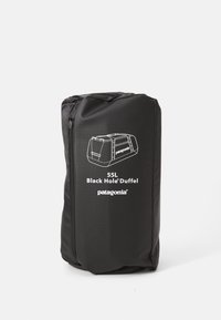 Black Patagonia 55L Black Hole Duffel bag in its compact storage pouch with zipper and white logo on the front.