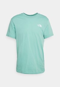 Miętowa bawełniana koszulka z okrągłym dekoltem i krótkimi rękawami. Ma małe białe logo na lewej części klatki piersiowej. Miękka w dotyku.