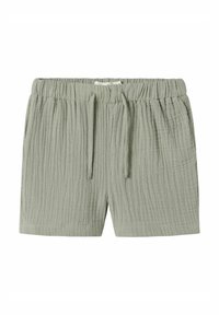 Pantaloni corti verde chiaro realizzati in tessuto di cotone testurizzato, con vita elastica e cordoncino, caratterizzati da un motivo leggermente stropicciato.