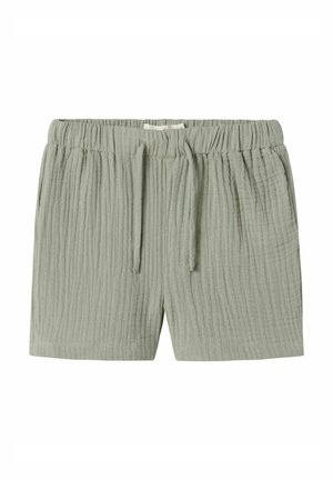 Ljusgröna shorts i texturerad bomull med elastisk midja och dragsko, med ett subtilt rynkat mönster.