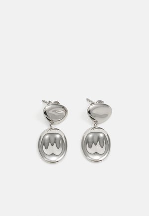 Silver drop earrings featuring a polished, rounded top and a circular, reflective pendant with a wavy pattern.