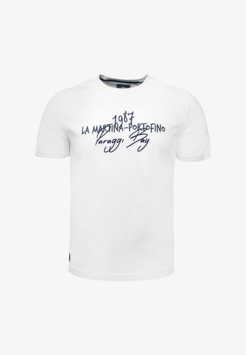 Biała bawełniana koszulka z okrągłym dekoltem i krótkimi rękawami. Na piersi w granatowym kolorze umieszczony jest napis "1987 LA MARTINA-PORTOFINO Paraggi Bay."