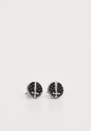 Round silver stud earrings with a black textured surface, featuring a central accent and scattered small details.