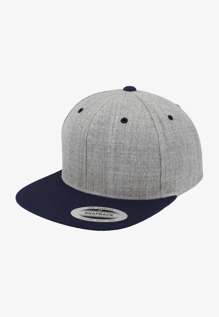 Gray snapback cap with a textured body and a solid navy brim. Features a black button on top and ventilation eyelets. Label on the brim.