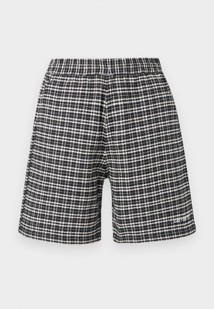 Zwart-witte geruite korte broek met elastische tailleband en klein logo op het linkeronderbeen.