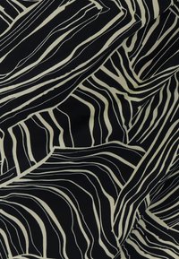 Black fabric featuring a swirling line pattern in cream. The design has varying widths and smooth textures, creating a wave-like effect.