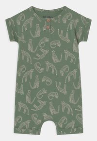 Zielony kombinezon z krótkim rękawem z całkowitym wzorem zarysowanych kotów. Wykonany z miękkiego materiału, z zapięciem na guziki oraz napami na dole.