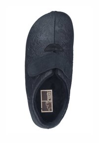 Black slipper with an embossed floral pattern. Soft material, rounded toe, adjustable Velcro strap, and seamless interior lining for comfort.