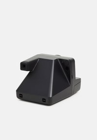 Black camera with a geometric shape, featuring a textured surface, a lens protruding from one side, and several buttons on the back.
