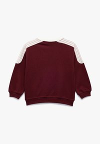 Bordeauxfarbenes Sweatshirt mit weißen Streifen an den Schultern, Rundhalsausschnitt, langen Ärmeln und gerippten Bündchen und Saum. Aus weichem Baumwollmischgewebe.