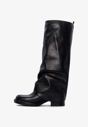 Czarne skórzane botki sięgające kolan o luźnym fasonie i zaokrąglonym nosku. Kwadratowy obcas oraz minimalne detale przeszycia podkreślają ich elegancki wygląd.