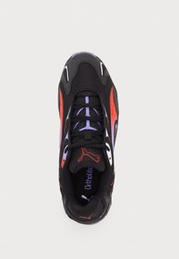 Black athletic shoe featuring mesh material, purple and red accents, and a textured sole. Laces are purple, with a logo on the tongue.