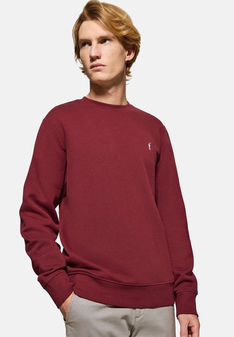 Burgundy sweatshirt i bomullsmix, med ribbat rundhals, långa ärmar och en liten broderad logotyp på bröstet.