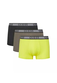 Trois paires de boxers pour hommes avec un design noir, marron et jaune fluo. Chacune a une ceinture grise avec la marque "GUESS".