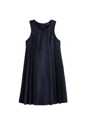 Chaleco negro sobre una camisa blanca de manga larga. El chaleco cuenta con cuatro botones redondos y un escote ligeramente curvado, con tela texturizada y cabello rizado.