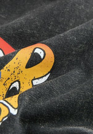 Black fabric displaying a colorful, graphic print featuring yellow and white accents, with a textured surface and wavy folds.