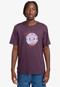 Purple cotton t-shirt with a round neckline, featuring a light blue and orange graphic design of a bird and landscape on the front.