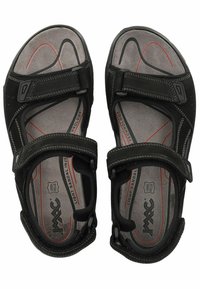 Schwarze Sandalen mit verstellbaren Riemen, weicher Innenauskleidung, strukturierten Sohlen und minimalistischen Design. Mit Logo und kontrastierenden Nähten.