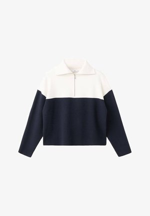 Granatowo-kremowy pulower z blokowym wzorem kolorów, z zamkiem na kołnierzu, luźnym krojem oraz prążkowaną fakturą na dole i mankietach. Wykonany z miękkiego materiału.