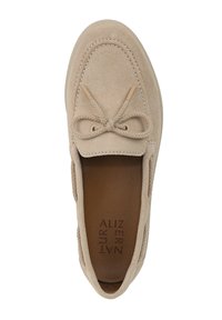 Beige suede slip-on shoe with a rounded toe, stitched detailing, and a decorative bow at the front. Interior features a brown insole.