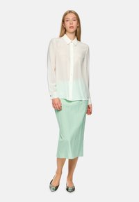 White, sheer button-up blouse with a gradual mint green dip-dye. Paired with a mint pleated midi skirt and floral pointed-toe shoes.