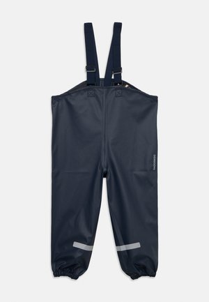 Navy waterproof bib pants with adjustable shoulder straps, elasticated ankles, and reflective strips above the cuffs.