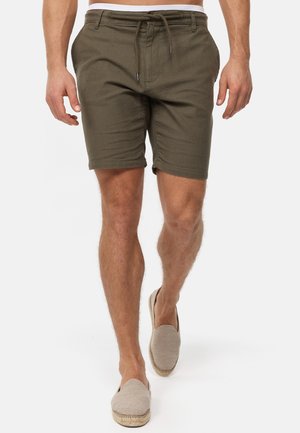 Shorts vert olive en tissu avec une finition texturée, dotés d'une taille élastique avec cordon de serrage. Coupe décontractée avec des poches latérales.