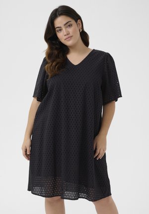 Black V-neck dress with short sleeves, featuring a textured design with open diamond patterns, loose fit, and knee-length hem.