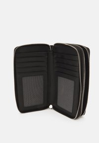 Black leather wallet with a zip closure. Features multiple card slots and two transparent ID windows. Smooth texture with silver zipper.