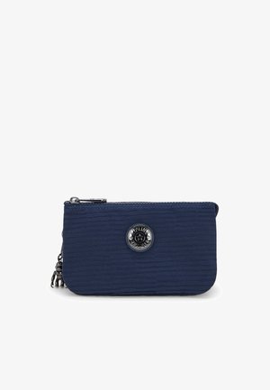 Navy blue textured pouch with a zip closure. Features a round metallic logo accent in the center and a decorative charm on the side.