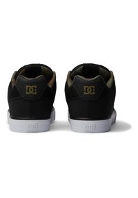 Black sneakers with textured fabric and a smooth leather heel; features white rubber sole and gold logo accents on the back.