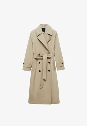 Bež plašč s dvojno zadrgo spredaj, velikimi reverji, pasom z zavezo v pasu in črnimi gumbi. Dolgi, ravno krojeni rokavi.