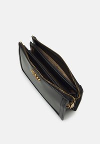 Schwarze Lederbörse mit goldenen Reißverschlüssen, zwei Fächern und mehreren Kartenfächern. Glatte Textur und minimalistisches Design.