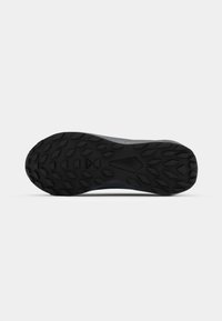 Black rubber shoe sole with a textured design featuring diamond-shaped patterns for traction and stability. Streamlined shape with subtle accents.